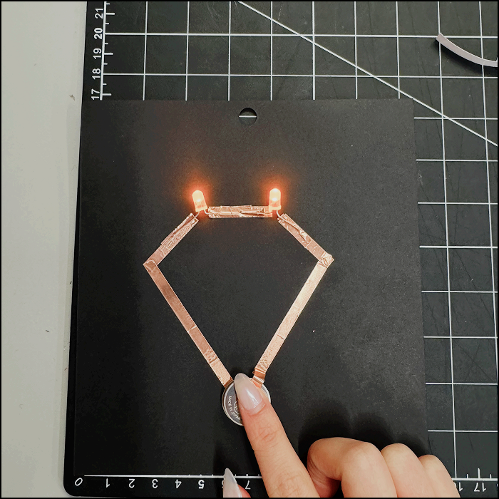 Image of experimentation, modified series circuit with positive side of the copper tape fully pressed on the battery.