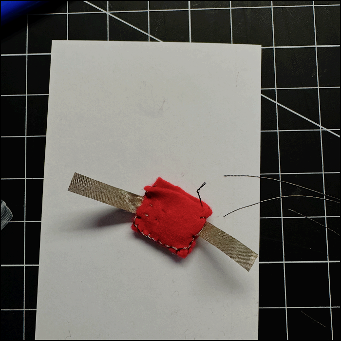 Image of completed battery holder, didn't fully work on circuits unless both sides were pressed togethert to make sure the conductive fabric touched more of the surface area of the battery