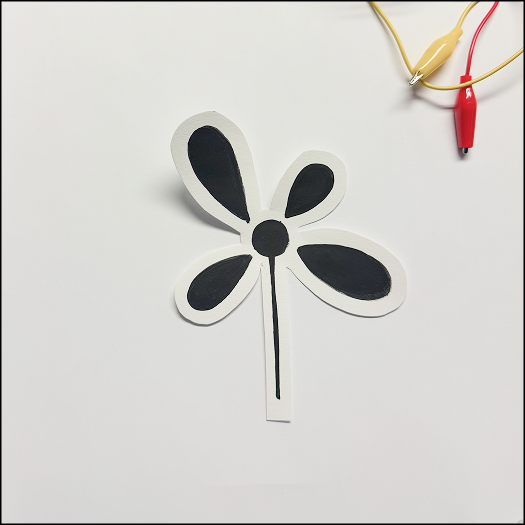 Creating a paper prototuype of flower design with conductive paint.